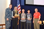 Naval Surface Warfare Center, Carderock Division Commanding Officer Capt. Mark Vandroff (left) and Carderock Division Technical Director Dr. Tim Arcano (right) pose with Sean Power from Chesapeake Math Program in Columbia, Md.; Joshua Fu from Basis Independent McLean in McLean, Va; and Fang Du from Roberto Clemente Middle School in Germantown, Md., who placed first, second and third, respectively, in the Carderock Math Contest, in West Bethesda, Md., March 24, 2017. (U.S. Navy photo by Devin Pisner/Released)