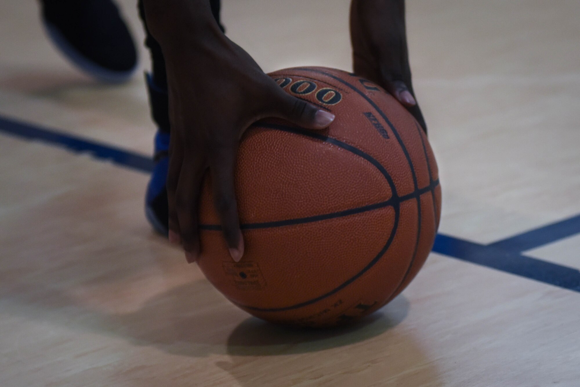 A basketball player reaches for the ball resume play during the first game of the Basketball Championship at Barksdale Air Force Base, La., April 18, 2017. In a double elimination style tournament, the 2nd Security Forces Squadron basketball team came in with zero losses and the 2nd Force Support Squadron basketball team had one loss. (Air Force photo/Airman 1st Class Stuart Bright)