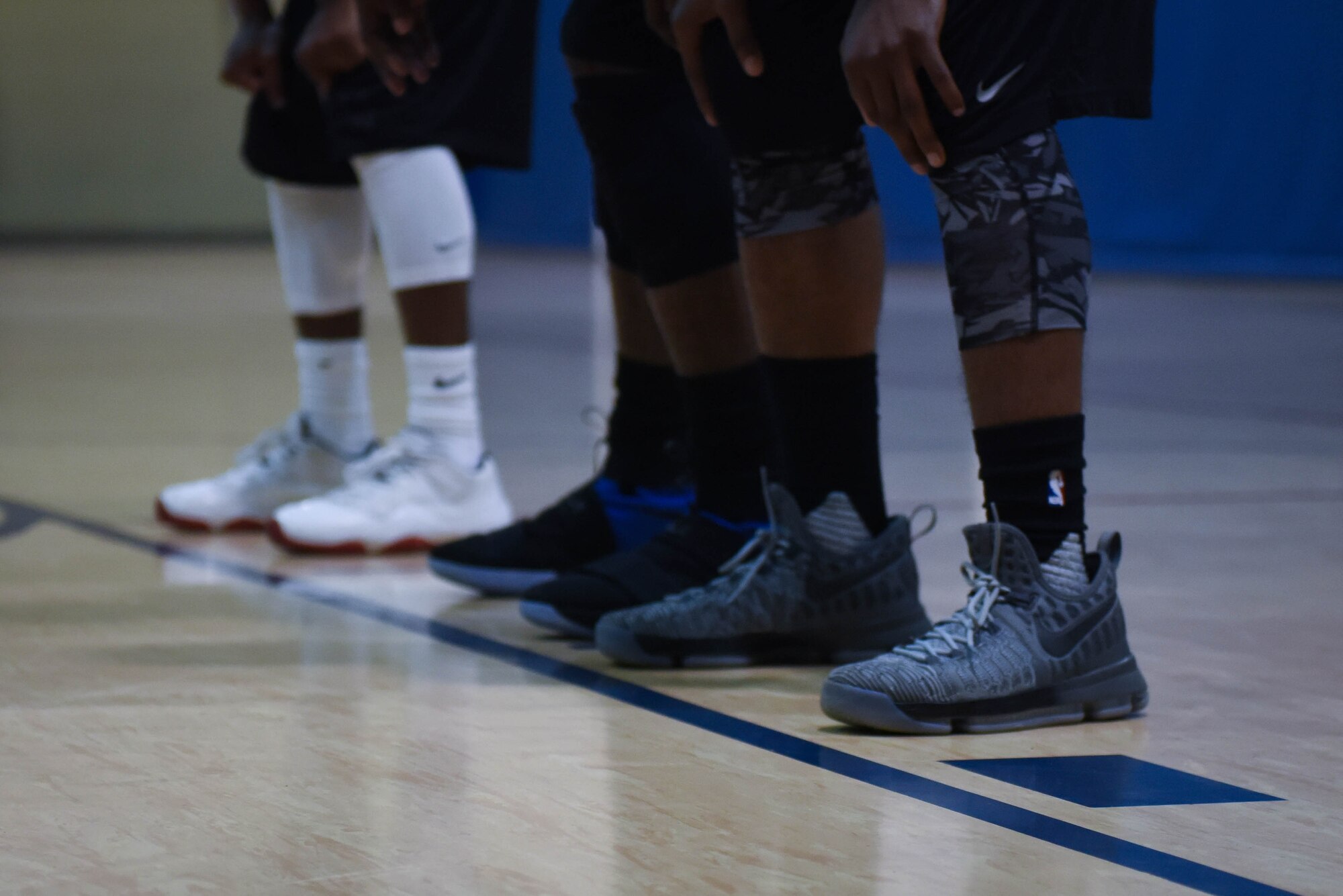 Members of the 2nd Security Forces Squadron basketball team and 2nd Force Support Squadron basketball team wait outside the key for the free throw to be taken at Barksdale Air Force Base, La., April 18, 2017. The Defenders won the second game 46-39 which made them champions of the basketball tournament. (Air Force photo/Airman 1st Class Stuart Bright)