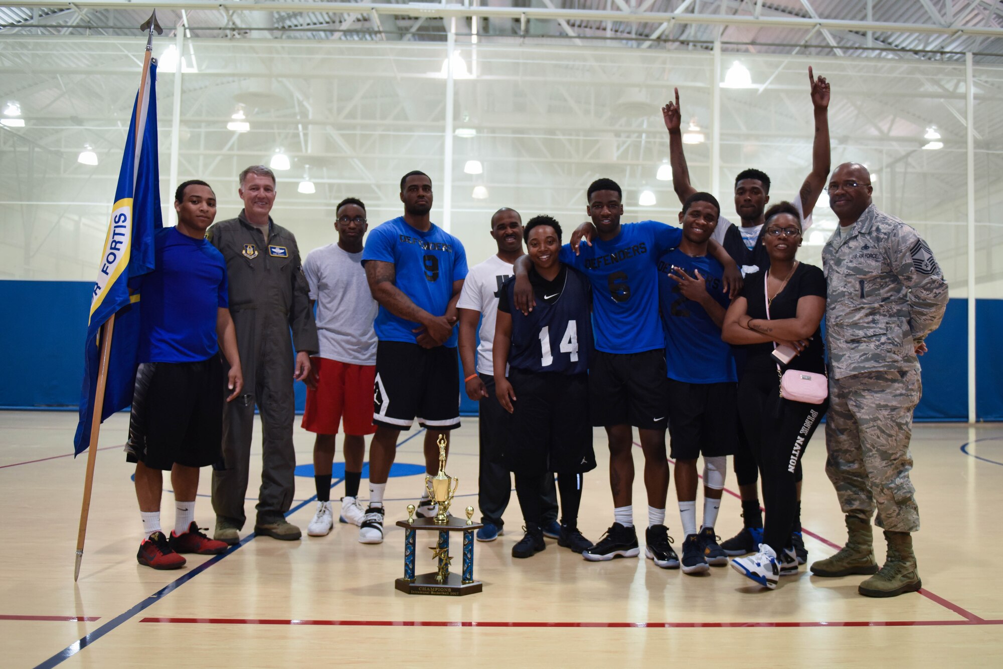 The 2nd Security Forces Squadron basketball team poses with their trophy after defeating the 2nd Force Support Squadron basketball team in two games at Barksdale Air Force Base, La., April 18, 2016. The Defenders won game two 46-39 to clinch the title. (Air Force photo/Airman 1st Class Stuart Bright)