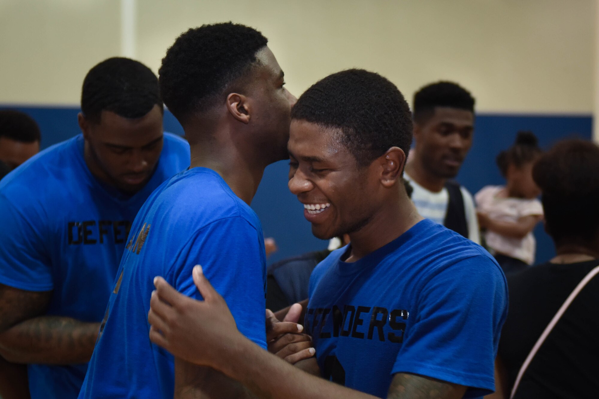 2nd Security Forces Squadron players embrace in celebration after their win against the2nd Force Support Squadron basketball team at Barksdale Air Force Base, La. April 18, 2016. Jerry Cannon III, 2SFS player, scored 12 of his team’s 46 points in the second game to help in winning the tournament. (Air Force photo/Airman 1st Class Stuart Bright)