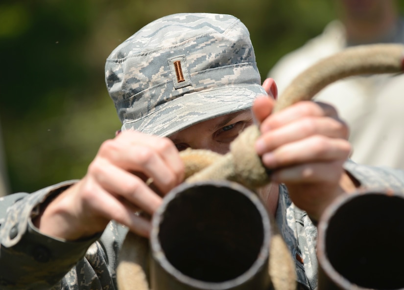 U.S. Air Force 2nd Lt. Peter Last, 633rd Civil Engineer Squadron operations engineer element officer in charge, ties a knot on a pipe during a Prime Base Engineer Emergency Force training at Joint Base Langley-Eustis, Va., April 20, 2017. The training took place at the obstacle and leadership reaction courses at Fort Eustis, Va., to help build morale and confidence. (U.S. Air Force photo/Airman 1st Class Kaylee Dubois)