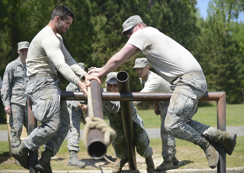U.S. Air Force Airmen assigned to the 633rd Civil Engineer Squadron move a pipe across a moat during a Prime Base Engineer Emergency Force training at Joint Base Langley-Eustis, Va., April 20, 2017. The training is held at the leadership reaction course to encourage the Airmen to communicate, learn each other’s skills and sharpen their confidence. (U.S. Air Force photo/Airman 1st Class Kaylee Dubois)