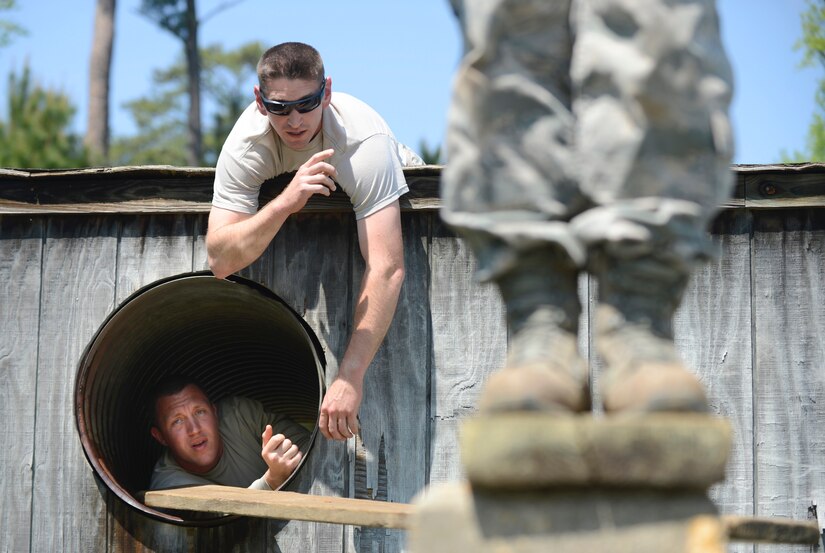 U.S. Air Force Tech. Sgt. Rodger Jones and Staff Sgt. Matthew Lawrence, 633rd Civil Engineer Squadron pavement and construction equipment technicians, participate during a Prime Base Engineer Emergency Force training at Joint Base Langley-Eustis, Va., April 20, 2017. Each team is required to move items and themselves across a water obstacle in under 20 minutes.  (U.S. Air Force photo/Airman 1st Class Kaylee Dubois)