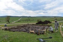 Staff Sgt. Michael Sarkkinen, Spc. Dynarious Dunmeyer, and Pvt. Laureece Stevens of Charleston, SC, 1223rd Engineer Company, 778th Engineer Battalion, South Carolina Army National Guard, lay grids during Resolute Castle 17 at Cincu Training Area, Romania, on 17 April 2017. These will mark positions for the corner posts on the Multi-Purpose Covered Shelter. The construction of such projects provides U.S. forces support in training themselves, the objective of which supports the resolve of the NATO alliance in responding to threats within the Eastern European region. (US Army photo by Capt. Colin J. Cutler, 926th Engineer Brigade)