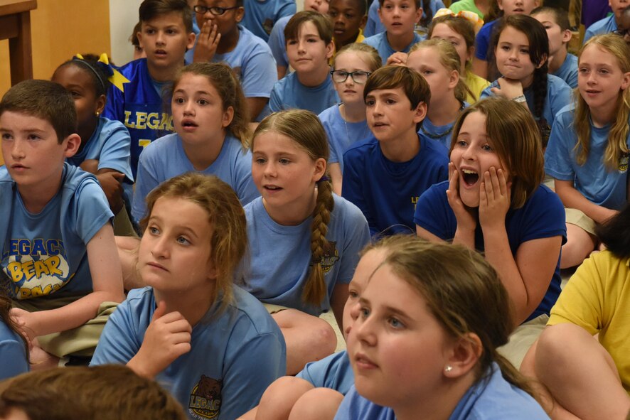 Kids from Legacy Elementary School watch a falconer and her bird during an Earth Day demonstration at Barksdale Air Force Base, La., April 21, 2017. Falconers are people who are approved by the U.S. Government to trap falcons and use them for hunting small game. (U.S. Air Force photo/Senior Airman Luke Hill)