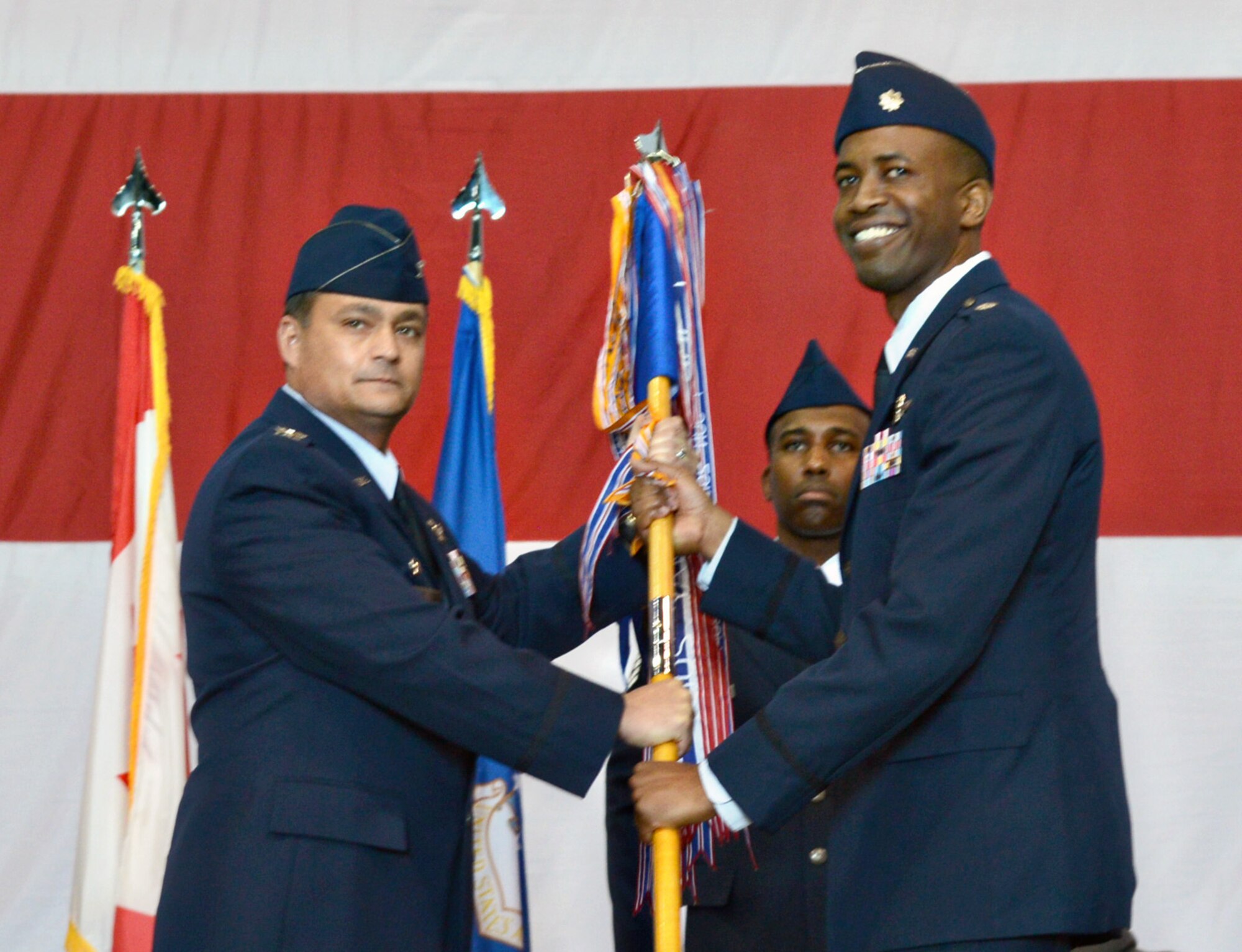 552nd Operations Group Commander Col. Richard Land III passes the guidon for the 966th Airborne Air Control Squadron to the new squadron commander, Lt. Col. Lonzo Wallace, during a change of command ceremony April 14.  Lt. Col. Christian Egan relinquished command during the ceremony and 1st Sgt. Henry McRoberts served as the guidon bearer.  The 966th AACS is the largest Formal Training Unit conducting training in ther Air Force's only Programmed Flying Training unit for the E-3B/C AWACS.  The 966th trains 625 students annually for the E-3 Initial Qualifications and Upgrade Training Courses, involving over 33 Air Force syllabi for 15 unique crew positions, more than 2,700 flying hours and $1.6 Billion, in assets.