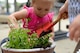 Two Team Shaw children add soil to a pot at the 20th Force Support Squadron Child Development Center (CDC) at Shaw Air Force Base, S.C., April 21, 2017. The CDC hosted the Earth Day gardening event for children and their families to participate in the planting of flowers and herbs. (U.S. Air Force photo by Airman 1st Class Kathryn R.C. Reaves)