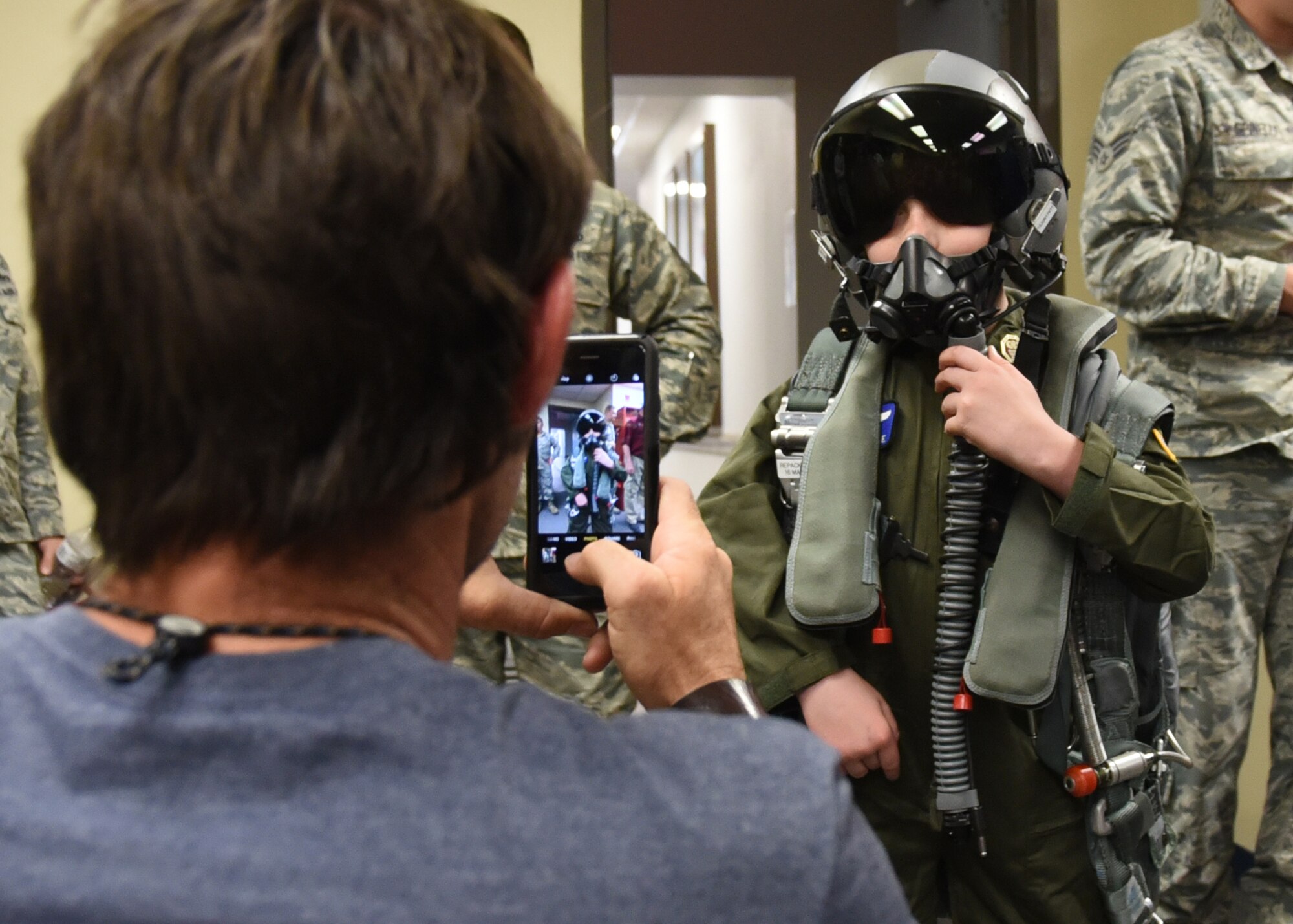 Honorary pilot Caleb Melville has a picture taken by his father, Isaiah Melville, while wearing flight equipment in the 2nd Fighter Training Squadron at Tyndall Air Force Base, Fla., April 21, 2017. Caleb became an honorary pilot through Tyndall’s pilot for a day program with help from the Shaddai Shriners children’s hospital. (U.S. Air Force photo by Airman 1st Class Isaiah J. Soliz/Released)