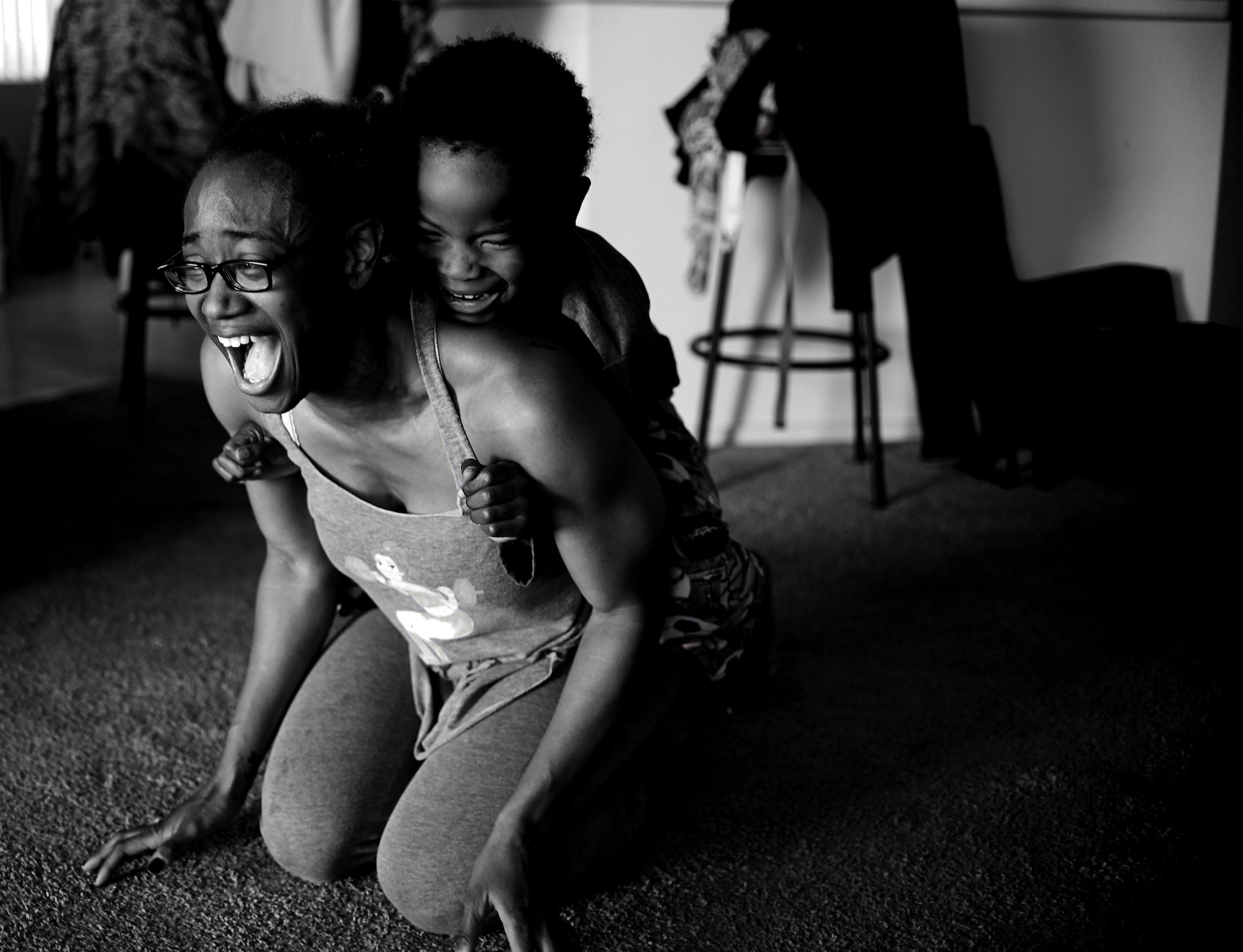 Semaj, 432nd Aircraft Maintenance Squadron supply craftsman, and her son Jamel, 6, play together April 2, 2017, at their home in Las Vegas. Semaj is able to compete successfully in women’s bodybuilding as a nationally qualified amateur while being a single mother. (U.S. Air Force photo/Senior Airman Christian Clausen)