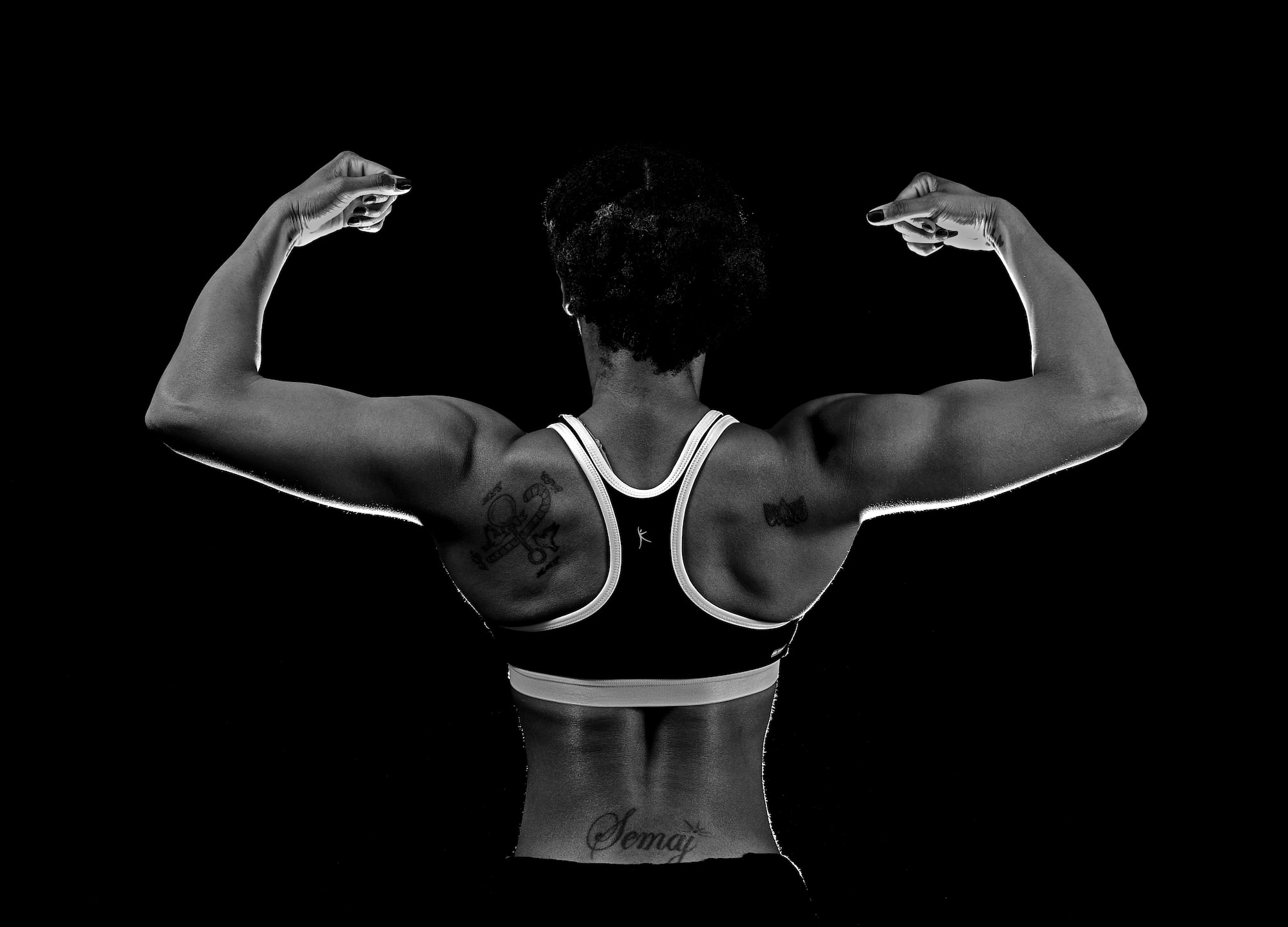 Staff Sgt. Semaj, 432nd Aircraft Maintenance Squadron supply craftsman, displays her back pose March 27, 2017, at Creech Air Force Base, Nev. Semaj is a nationally qualified amateur bodybuilder competing in the figure category. (U.S. Air Force photo/Senior Airman Christian Clausen)