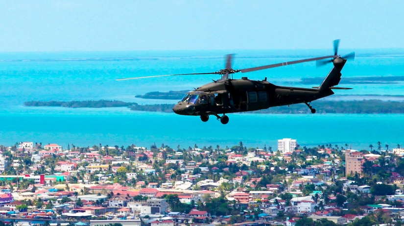 A UH-60 Blackhawk helicopter from A Company, 1/150th Assault Helicopter Battalion, flies over Belize City while transporting Soldiers and Marines on their way back from Dangriga, Belize, April 10, 2017. The 1/150th is providing lift support and medevac, if necessary, for Beyond the Horizon 2017, a U.S. Southern Command-sponsored, Army South-led exercise designed to provide humanitarian and engineering services to communities in need, demonstrating U.S. support for Belize. (U.S. Army Photo by Sgt. Joshua E. Powell)