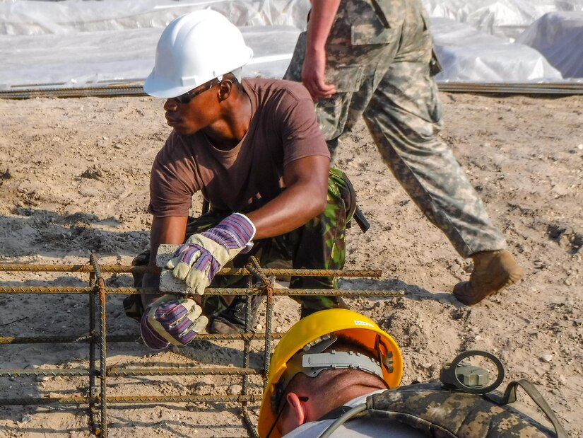 A soldier with the Belize Defense Force secures a chair to a rebar footer cage, which is being prepared for placement at the Double Head Cabbage Clinic, Double Head Cabbage, Belize, April 1, 2017. The 672nd Engineer Company was deployed to Belize in support of Beyond the Horizon, U.S. Army South and U.S. Southern Command’s annual multinational humanitarian and civic assistance program (Courtesy Photo).