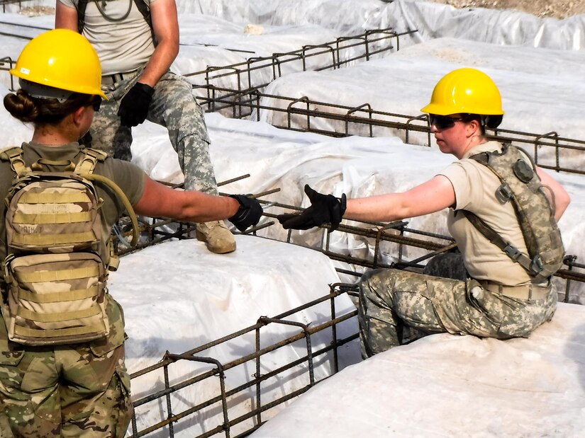 Pvt. Jade Smith of the 672nd Engineer Company, left, hands a pair of pliers to Spc. Haley Goodin as she ties together rebar at the Double Head Cabbage Health Clinic, in Double Head Cabbage, Belize, April 1, 2017. The soldiers were deployed to Belize in support of Beyond the Horizon, U.S. Army South and U.S. Southern Command’s annual multinational humanitarian and civic assistance program (Courtesy Photo).