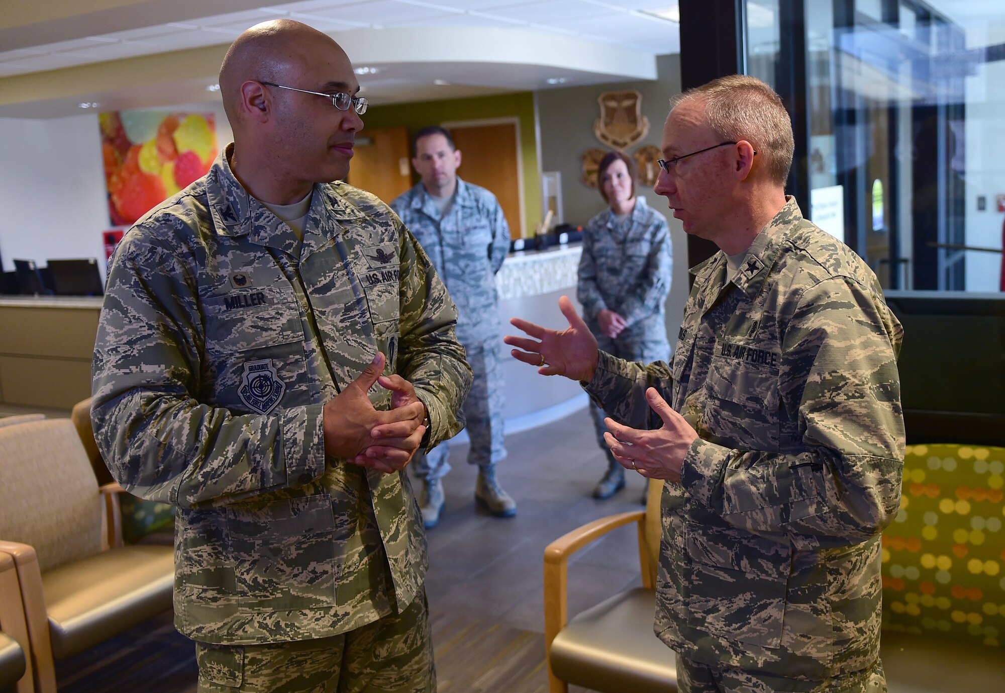 Col. David Miller, Jr., 460th Space Wing commander, speaks with Brig. Gen. James Burks, Director, Manpower, Personnel, and Resources Corps Chief, Medical Service Corps, April 25, 2017, on Buckley Air Force Base, Colo. Burks toured the medical facilities on base and was briefed the status of each unit. (U.S. Air Force photo by Airman Jacob Deatherage/Released)