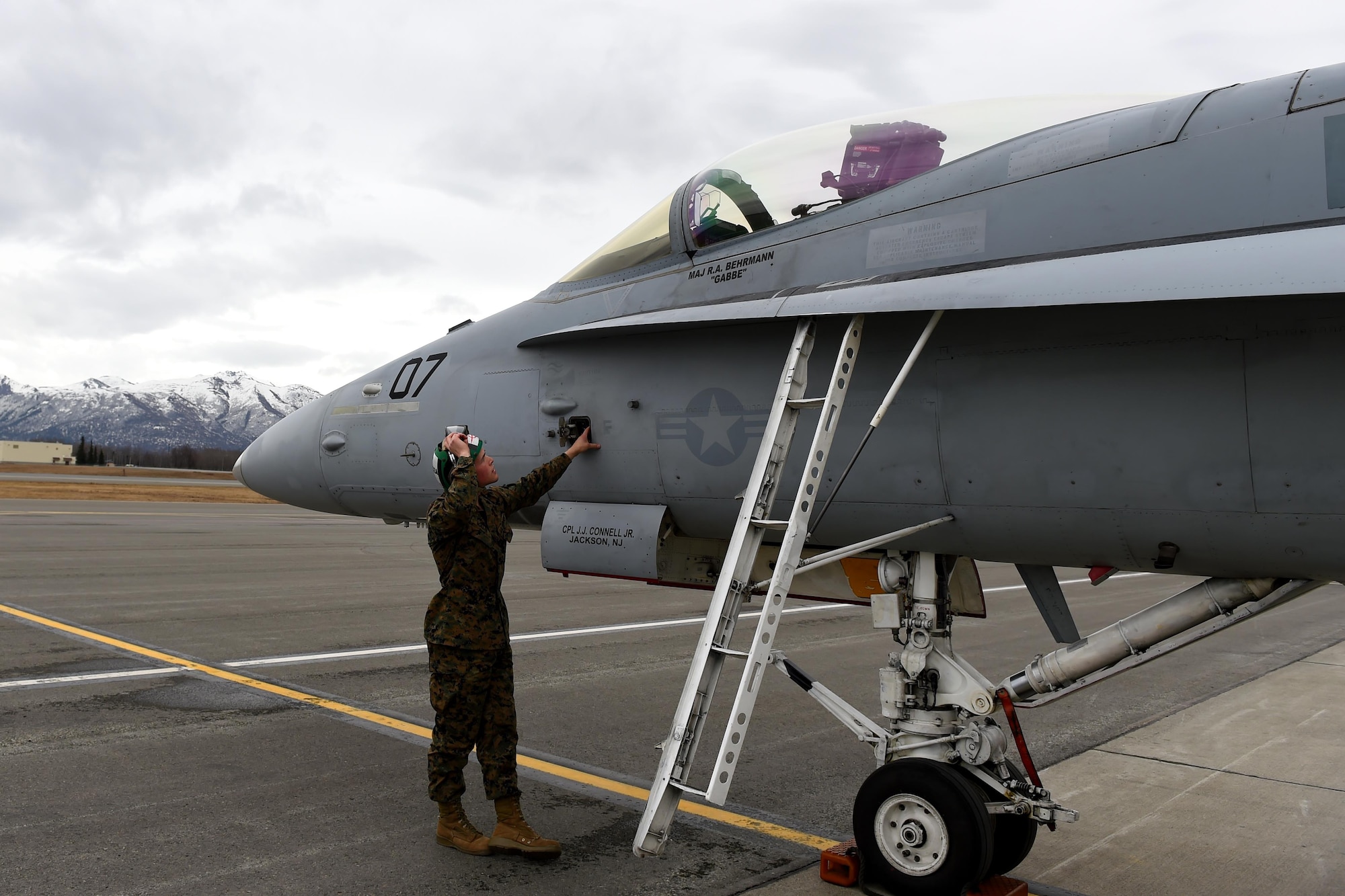 U.S. Marine Corps Sgt. Dominic Schulte, Marine Fighter Attack Squadron 232 flight equipment technician from Miramar, Calif., closes the cockpit of an FA-18C Hornet from his squadron at the flight line at Joint Base Elmendorf-Richardson, Alaska, for Exercise Northern Edge, April 24, 2017. Various military aircraft from all services will practice operations, techniques and procedures while enhancing interoperability during Northern Edge 2017 – Alaska’s premier joint-training exercise. 