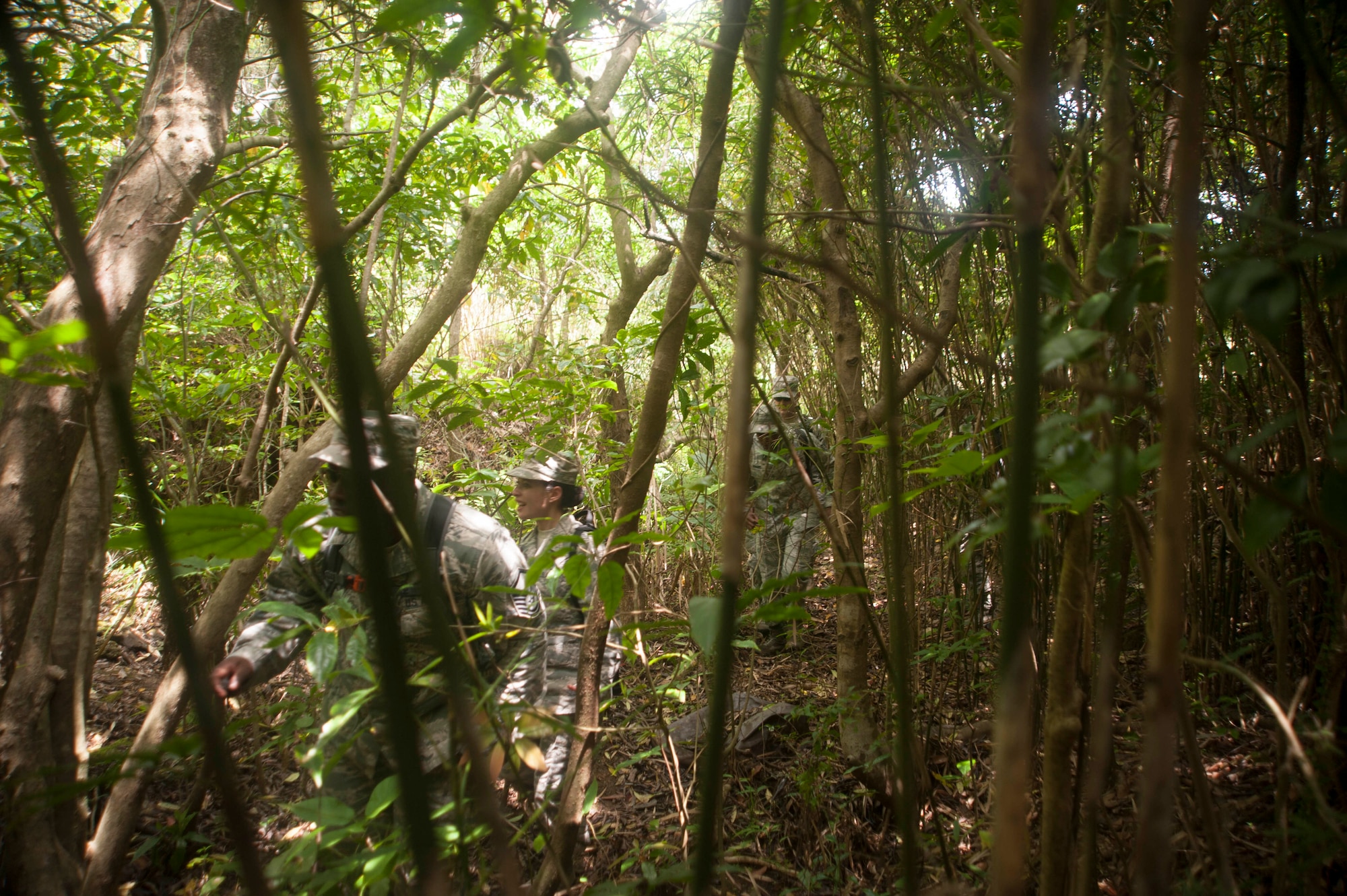 U.S. Air Force Airmen assigned to the 18th Medical Group navigate a jungle as part of the Preventative Aerospace Medicine Convention April 21, 2017, at Kadena Air Base, Japan. The PAMACON was designed to test the knowledge and capabilities of the 18th MDG regarding the setup and maintenance requirements for deployed locations. (U.S. Air Force photo by Airman 1st Class Quay Drawdy)