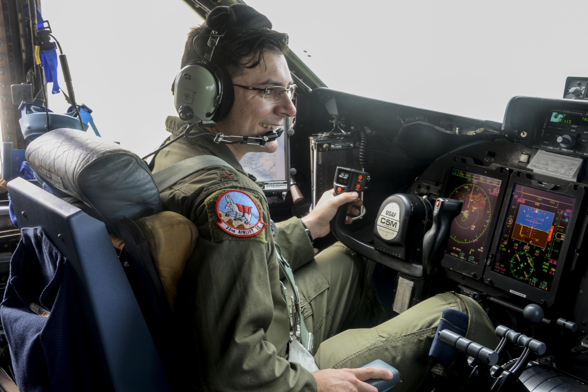 Maj. Matt Bartomeo, 22nd Airlift Squadron, is all smiles during his first C-5M Super Galaxy flight in over two years April 12 at Travis Air Force Base, California. Bartomeo fought Hodgkins Lymphoma for 14 months before being able to return to the cockpit. (U.S. Air Force photo / 2nd Lt. Sarah Johnson)