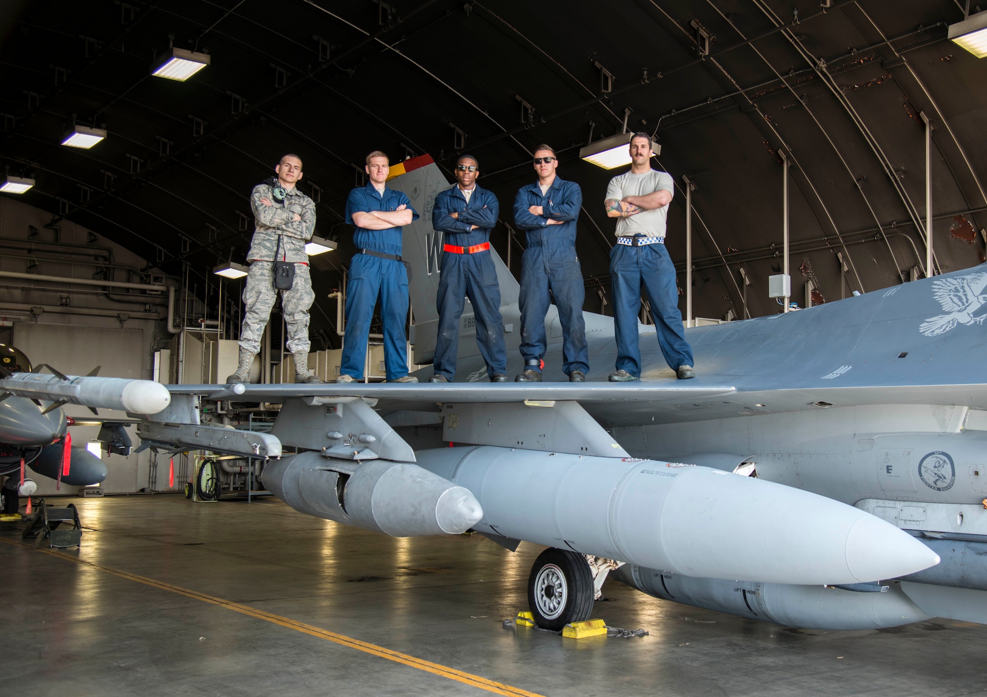 Airmen with the 13th Aircraft Maintenance Squadron pose for a photo on top of an F-16 Fighting Falcon at Misawa Air Base, Japan, April 20, 2017. The 13th AMXS worked tirelessly to ensure all the 13th Fighter Squadron's jets are 100 percent mission capable. (U.S. Air Force photo by Senior Airman Brittany A. Chase)