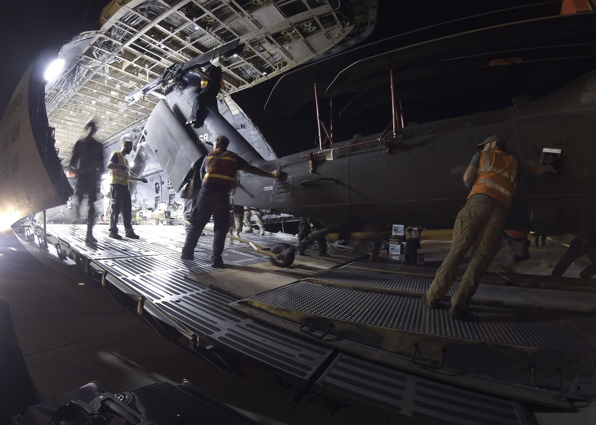An HH-60 Black Hawk helicopter is unloaded from a Team Dover C-5M Super Galaxy airlifter April 8, 2017, at Robert Gray Army Airfield, Texas. This was the fourth time Team Dover conducted a C-5 stage operation. (Courtesy photo)