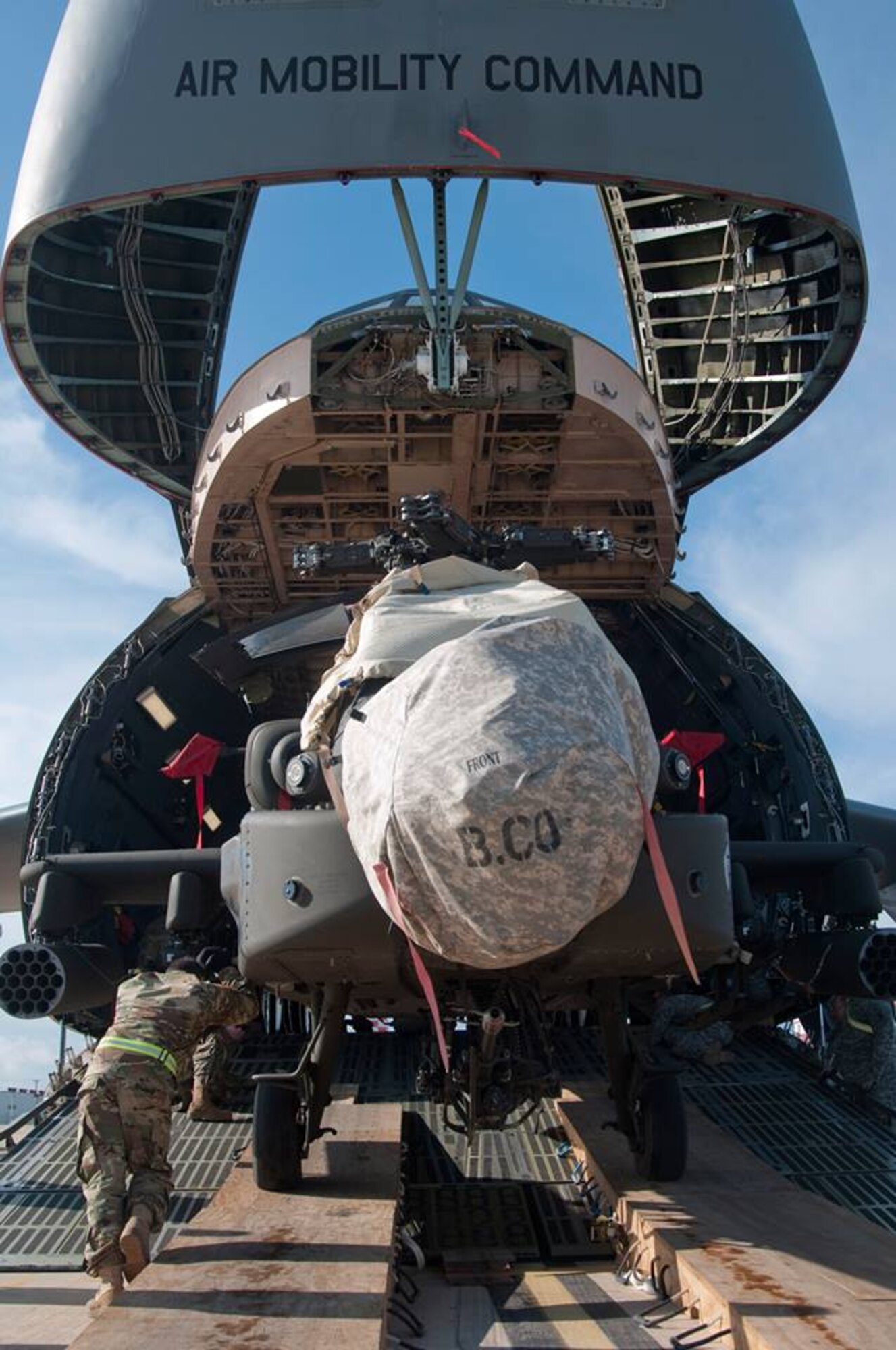 An AH-64 Apache helicopter is loaded onto a Team Dover C-5M Super Galaxy airlifter March 26, 2017, at Naval Station Rota, Spain. This was part of a U.S. Transportation Command Multimodal operation that deployment swapped two Army Aviation Brigades in and out of Afghanistan. (Courtesy photo)