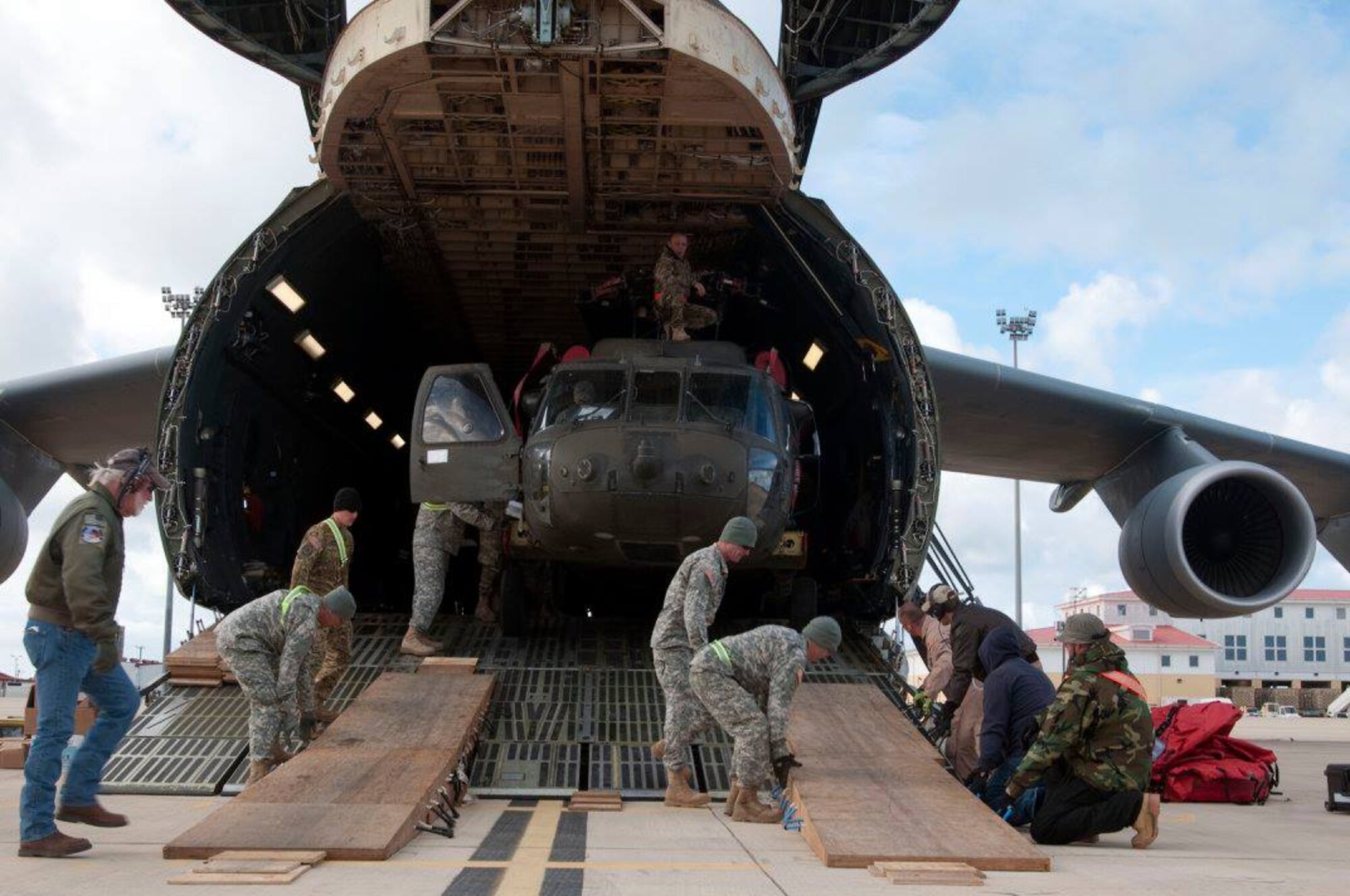 An HH-60 Black Hawk helicopter is unloaded from a Team Dover C-5M Super Galaxy airlifter March 26, 2017, at Naval Station Rota, Spain. The combined active duty and Reserve force used four Dover C-5Ms, flying more than 450 hours to transport 82 helicopters, 46 passengers, and support equipment totaling 2.6 million pounds over the duration of the mission. (Courtesy photo)