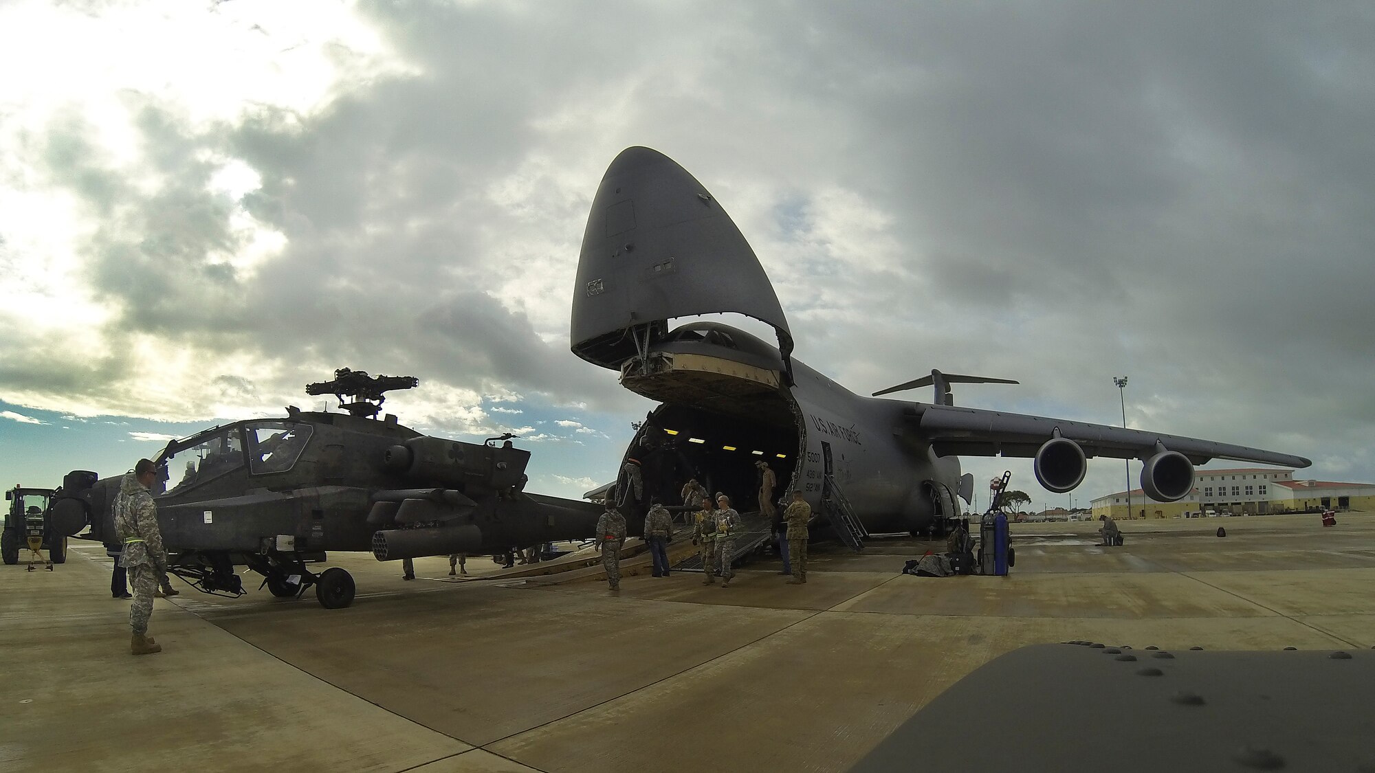 An AH-64 Apache helicopter is unloaded from a Team Dover C-5M Super Galaxy airlifter March 26, 2017, at Naval Station Rota, Spain. The aircrews were comprised of Airmen from the 9th and 709th Airlift Squadrons. (Courtesy photo)