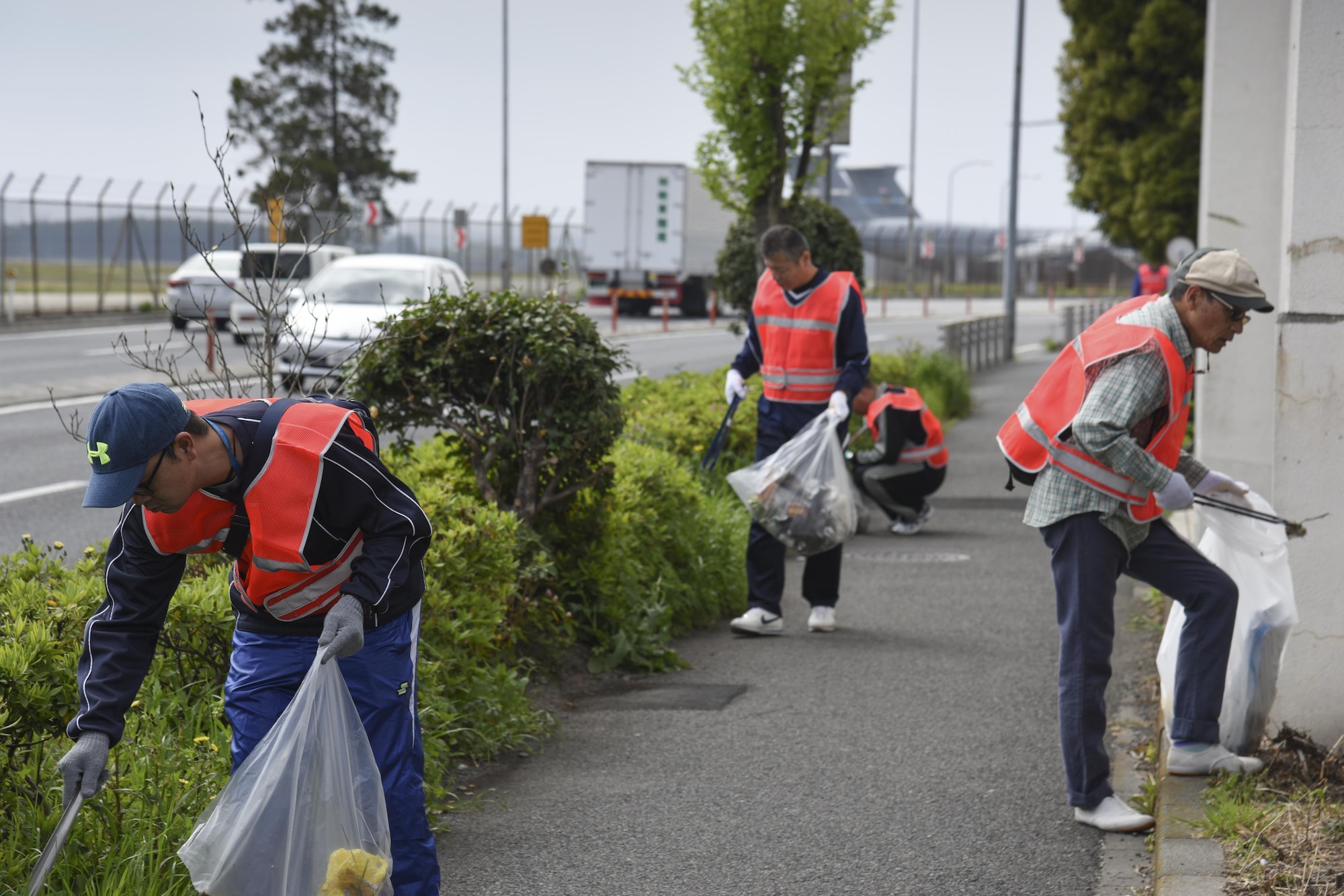 Japan Air Self-Defense Force members collect trash around the local area of Yokota Air Base during the Earth Day fence-line cleanup event April 22, 2017, at Yokota Air Base, Japan. Volunteers cleaned both inside and outside of the base. (U.S. Air Force photo by Machiko Arita)