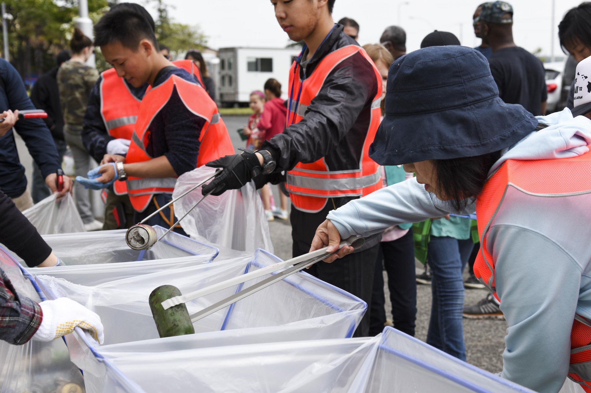 Volunteers sort out the collected trash during the Earth Day fence-line cleanup event April 22, 2017, at Yokota Air Base, Japan. 124 volunteers from Yokota community, including Airmen, civilian employees, family members, local national employees and members of Japan Air Self-Defense Force took part in the event. (U.S. Air Force photo by Machiko Arita)