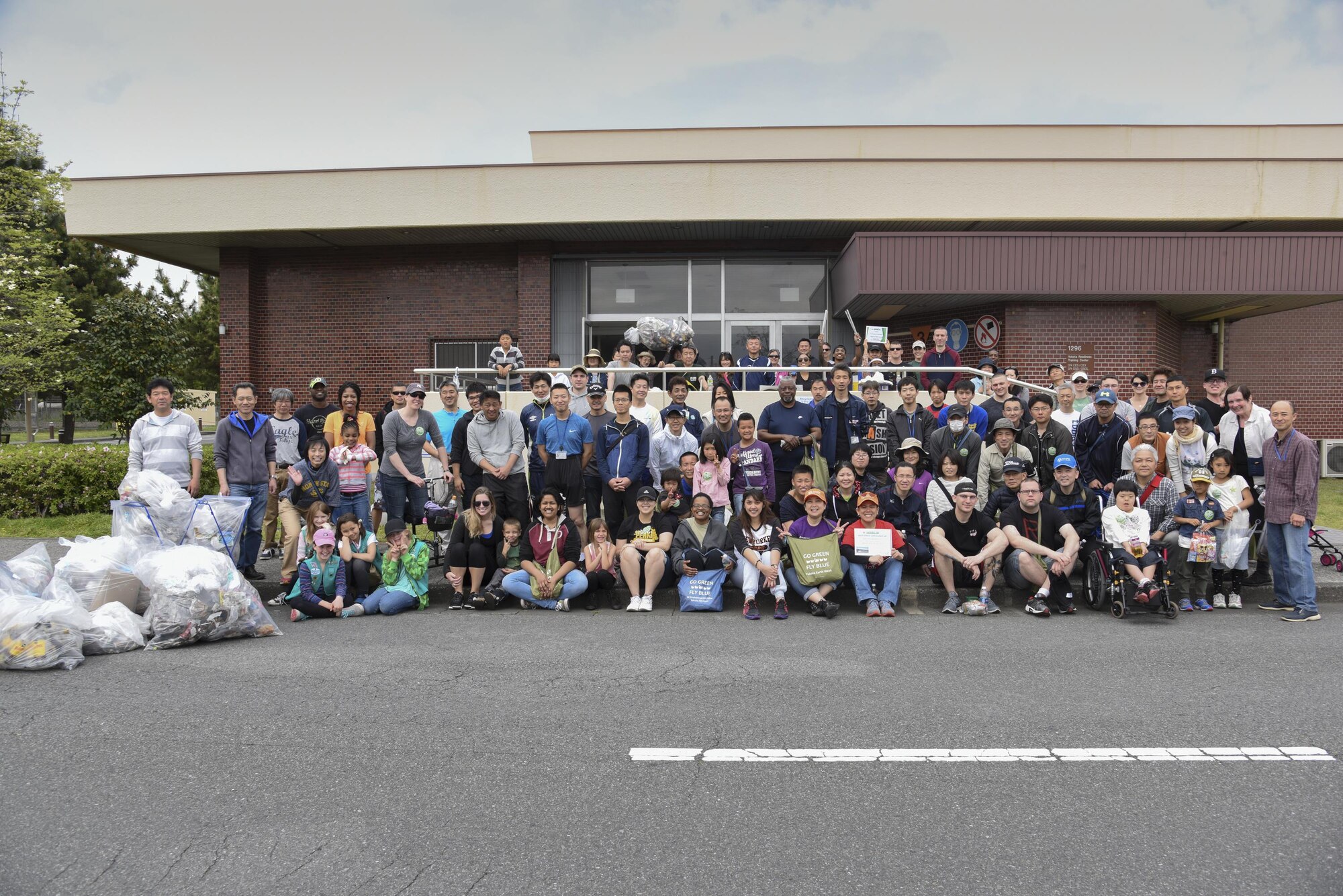 The volunteers that took part in the Earth Day fence-line cleanup event pose for a photo April 22, 2017, at Yokota Air Base, Japan. The 374th Civil Engineer Squadron hosted the event as part of the Earth Day ecofriendly activities. (U.S. Air Force photo by Machiko Arita)