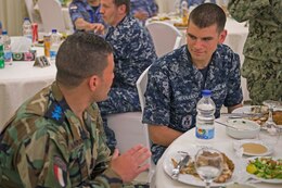 Information Systems Technician Seaman Nicholas Hernandez assigned to guided-missile destroyer USS Truxtun (DDG 103) talks to an Egyptian Navy SEAL during a welcome reception onboard Red Sea Naval Base for Exercise Eagle Salute 17. Eagle Salute/Eagle Response 17 is a multilateral exercise with Egypt, Saudi Arabia and United Arab Emirates to enhance mutual capabilities in maritime security operations. Truxtun is deployed to the U.S. 5th Fleet area of operations in support of maritime security operations designed to reassure allies and partners and preserve the freedom of navigation and the free flow of commerce in the region.