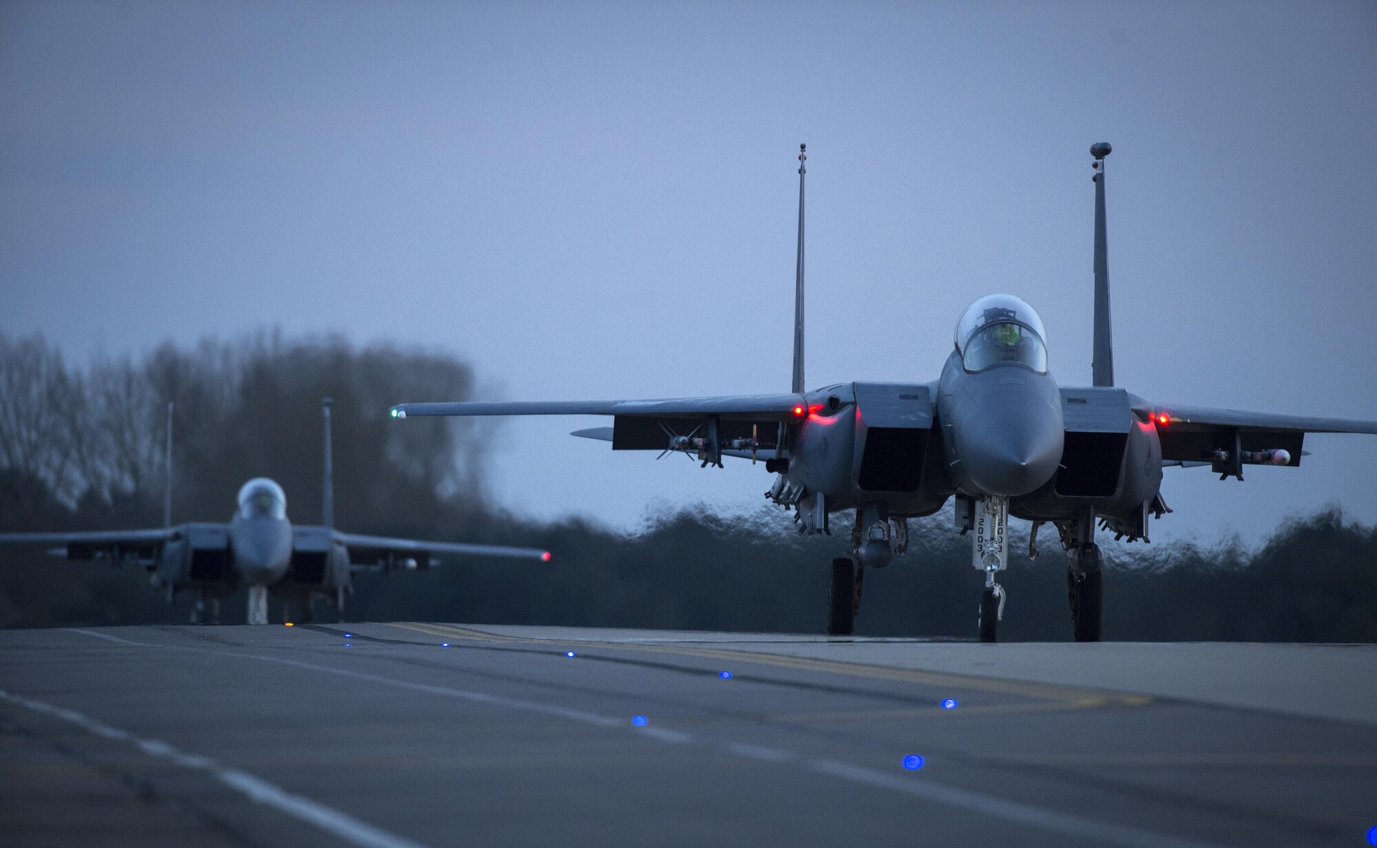 Two F-15E Strike Eagles taxi for take-off for a training sortie at Royal Air Force Lakenheath, England, April 19. Nighttime flying operations are required to maintain aircrew proficiency and ensure our pilots remain ready to meet future challenges. (U.S. Air Force photo/Staff Sgt. Emerson Nuñez)