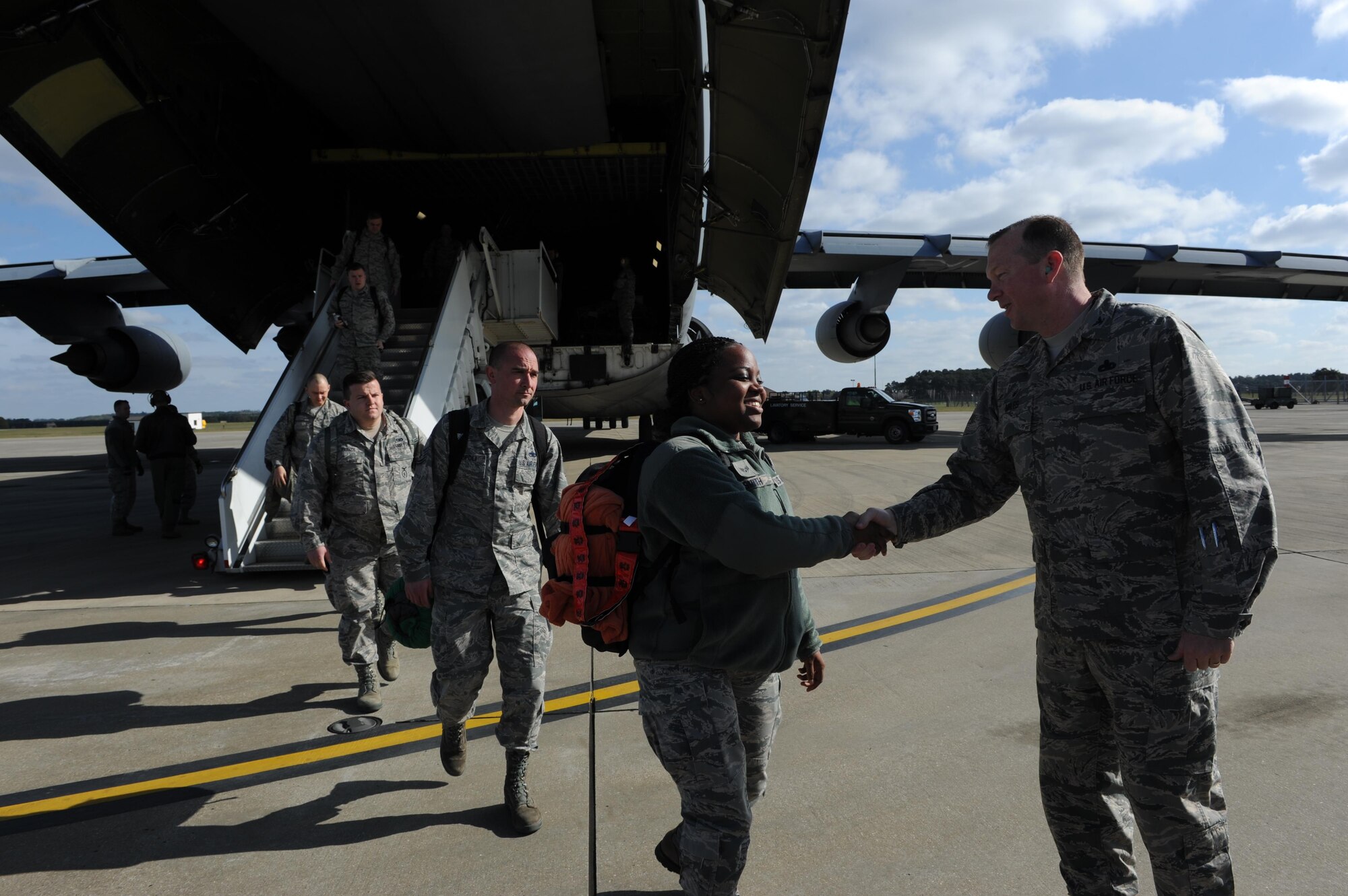 Senior Airman Jonique Smith, 34th Aircraft Maintenance Unit, is greeted by Col. Michael Miles, 388th Maintenance Group commander, as she arrives at Royal Air Force Lakenheath. This is Smith’s first deployment and her first time outside the United States. Smith and her fellow Airmen are at Lakenheath supporting the first overseas deployment of the F-35A. Smith is stationed at Hill Air Force Base, Utah and works in F-35A plans and scheduling. Her hometown is Compton, California. (U.S. Air Force photo/Micah Garbarino)