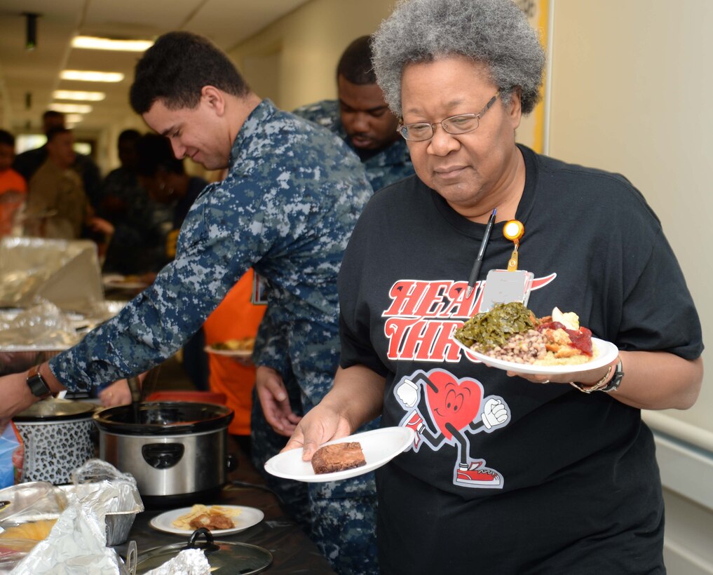 Naval Branch Health Clinic-Albany Sailors and civilian personnel prepare a feast to commemorate African-American heritage in a celebration at Marine Corps Logistics Base Albany, recently. The event, which began at the clinic, ended at the Base Theater, with a private showing of the movie, “Hidden Figures.”