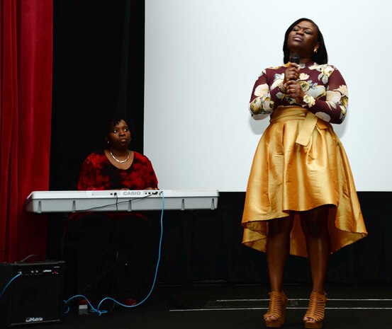 Shenika Clyde takes to the stage to commemorate Naval Branch Health Clinic-Albany’s African-American heritage, at Marine Corps Logistics Base Albany’s Base Theater, recently. Accompanied on keyboard by Suporah Murray, Clyde kicked off the program with a vocal solo and musical performance, which brought a roaring round of applause and cheers from attendees at a celebration. The event, which began at the clinic, ended at the Base Theater, with a private showing of the movie, “Hidden Figures.”