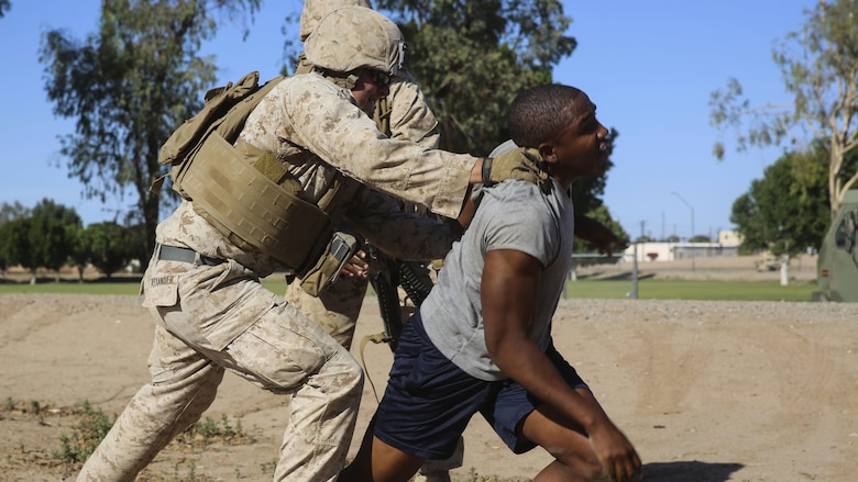 Marines supporting Marine Aviation Weapons and Tactics Squadron 1 subdue a role player during Assault Support Tactics 3 training while supporting the semiannual Weapons and Tactics Instructor Course 2-17 at Marine Corps Air Station Yuma, Arizona, April 21. Lasting seven weeks, WTI is a training evolution hosted by MAWTS-1 which provides standardized advanced and tactical training and certification of unit instructor qualifications to support Marine aviation training and readiness. The AST-3 training focused on conducting noncombatant evacuation operations in an urban environment while providing foreign humanitarian assistance to the simulated host nation. 