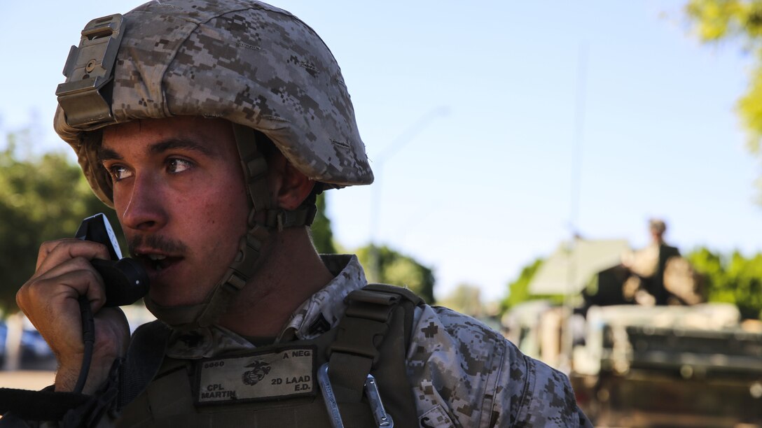 Cpl. Eric Martin, gunner with 2nd Low Altitude Air Defense, supporting Marine Aviation Weapons and Tactics Squadron 1, speaks into the loud speaker to subdue role players during Assault Support Tactics 3, supporting the semiannual Weapons and Tactics Instructor Course 2-17 at Marine Corps Air Station Yuma, Arizona, April 21. Lasting seven weeks, WTI is a training evolution hosted by MAWTS-1 which provides standardized advanced and tactical training and certification of unit instructor qualifications to support Marine aviation training and readiness. The AST-3 training focused on conducting noncombatant evacuation operations in an urban environment while providing foreign humanitarian assistance (FHA) to the simulated host nation.