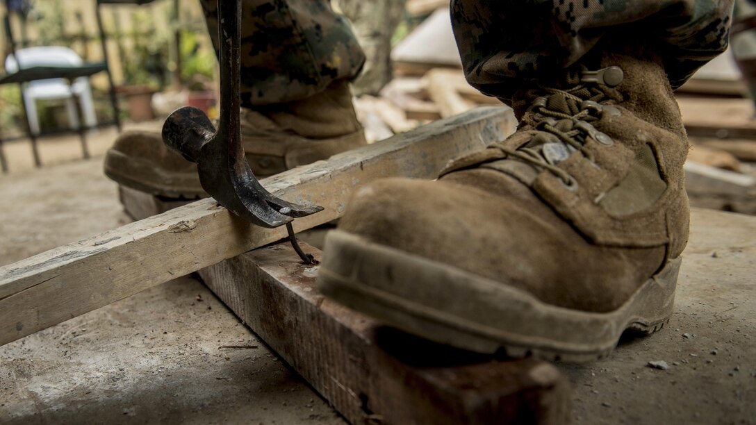 A U.S. Marine engineer extracts a nail from a wood beam during Balikatan 2017 in Ormoc, Leyte, April 23, 2017. Armed Forces of the Philippines and U.S. military engineers worked together to build a new classroom at Don Carlos Elementary School in Ormoc. Balikatan is an annual U.S.-Philippine military bilateral exercise focused on a variety of missions, including humanitarian assistance and disaster relief and counterterrorism. (U.S. Air Force photo by Staff Sgt. Peter Reft)