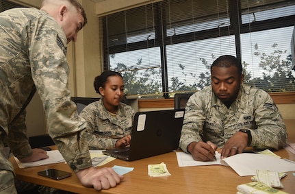 Staff Sgt. Jordan Stinson, left, 628th Comptroller Squadron financial analyst supervisor, Senior Airman Menebere Haileselassie, center, 628th CPTS travel technician, and Senior Airman Xavier Miles, right, 628th CPTS military pay technician, participate in a contingency contracting exercise at Joint Base Charleston, S.C., April 21, 2017. The 628th Contracting Squadron and 628th CPTS trained side-by-side during the exercise to test skillsets and knowledge of junior contracting and finance Airmen helping prepare them for a deployed environment. 