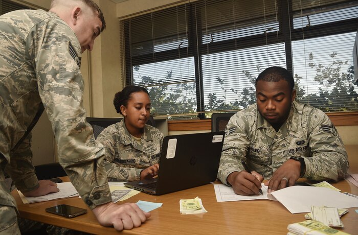 Staff Sgt. Jordan Stinson, left, 628th Comptroller Squadron financial analyst supervisor, Senior Airman Menebere Haileselassie, center, 628th CPTS travel technician, and Senior Airman Xavier Miles, right, 628th CPTS military pay technician, participate in a contingency contracting exercise at Joint Base Charleston, S.C., April 21, 2017. The 628th Contracting Squadron and 628th CPTS trained side-by-side during the exercise to test skillsets and knowledge of junior contracting and finance Airmen helping prepare them for a deployed environment. 