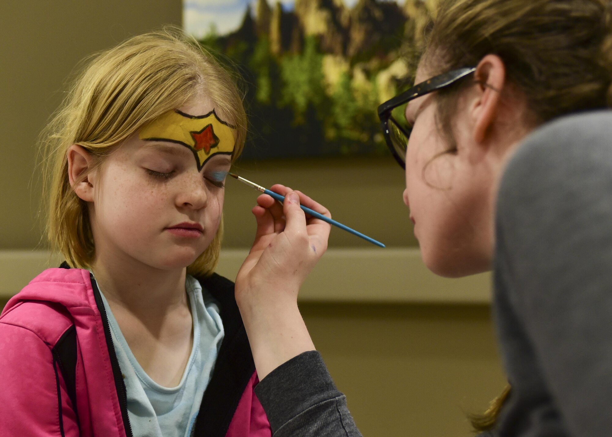 Jennifer Strickland, the daughter of 1st Lt. Daniel Strickland, the 28th Medical Readiness flight commander assigned to the 28th Medical Squadron, has her face painted by Jeena Simunek during the 2017 Children’s Fair inside the 28th Medical Group at Ellsworth Air Force Base, S.D., April 20, 2017. The Children’s Fair raises awareness for child abuse prevention, and provides parents with on and off-base family-centered resources. (U.S. Air Force photo by Airman 1st Class Randahl J. Jenson)  