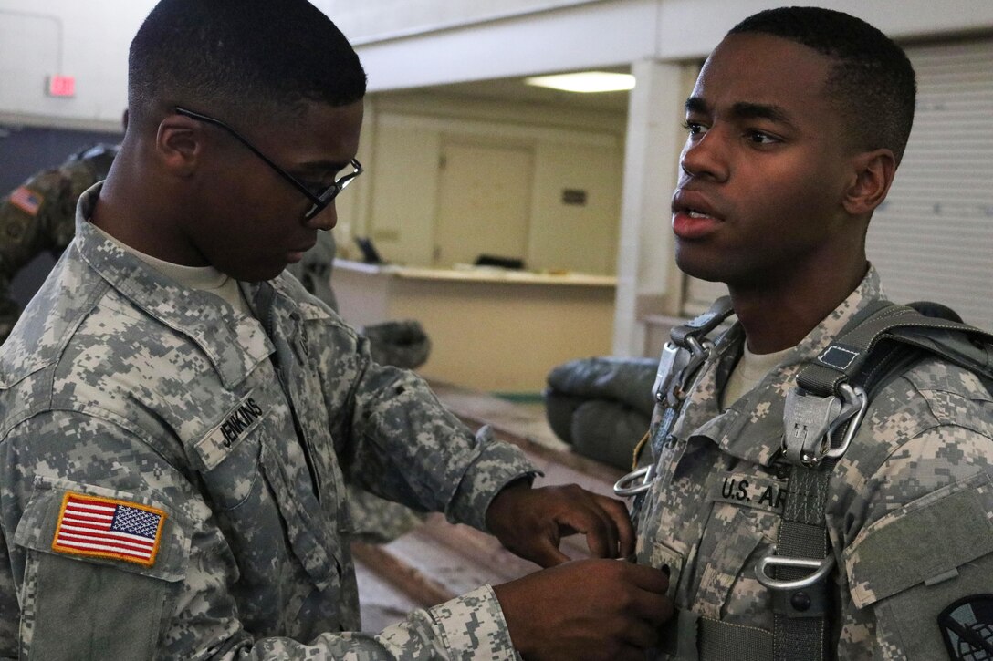 Army Spc. Khalil Jenkins, left, inspects a parachute harness belonging to Army Spc. Darius Davis during parachute training operations conducted at Pope Army Airfield located on Fort Bragg, N.C., April 21, 2017. Army photo by Sgt. 1st Class Bronco Suzuki