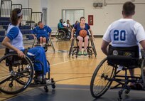 Sarah Ziaja, a Warrior CARE athlete, tries to find a teammate to pass to during the wheelchair basketball session of the adaptive sports camp at Eglin Air Force Base, Fla., April 25. The base hosts the week-long Wound Warrior CARE event that helps recovering wounded, ill and injured military members through specific hand-on rehabilitative training. (U.S. Air Force photo/Samuel King Jr.)