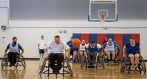 A Warrior CARE athlete races to catch up to a loose ball during the wheelchair basketball session of the adaptive sports camp at Eglin Air Force Base, Fla., April 25. The base hosts the week-long Wound Warrior CARE event that helps recovering wounded, ill and injured military members through specific hand-on rehabilitative training. (U.S. Air Force photo/Samuel King Jr.)