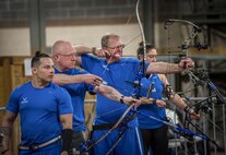 Warrior Games athletes are in various states of taking aim and firing at the bullseye during an archery session at the Air Force team’s training camp at Eglin Air Force Base, Fla., April 25. The base-hosted, week-long Warrior Games training camp is the last team practice session before the yearly competition in June. (U.S. Air Force photo/Samuel King Jr.)