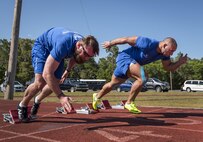 Justin Fuchs and Matt Cable, Warrior Games athletes, come off the blocks into a sprint during a track session at the Air Force team’s training camp at Eglin Air Force Base, Fla., April 25. The base-hosted, week-long Warrior Games training camp is the last team practice session before the yearly competition in June. (U.S. Air Force photo/Samuel King Jr.)