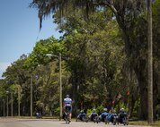 A line of Warrior CARE athletes travels along a powerline on recumbent bicycles during a cycling session of the adaptive sports camp at Eglin Air Force Base, Fla., April 25. The base hosts the week-long Wound Warrior CARE event that helps recovering wounded, ill and injured military members through specific hand-on rehabilitative training. (U.S. Air Force photo/Samuel King Jr.)