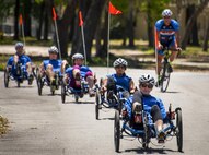 Eleanor Carlin leads a line of Warrior CARE athletes on recumbent bicycle ride during a cycling session of the adaptive sports camp at Eglin Air Force Base, Fla., April 25. The base hosts the week-long Wound Warrior CARE event that helps recovering wounded, ill and injured military members through specific hand-on rehabilitative training. (U.S. Air Force photo/Samuel King Jr.)