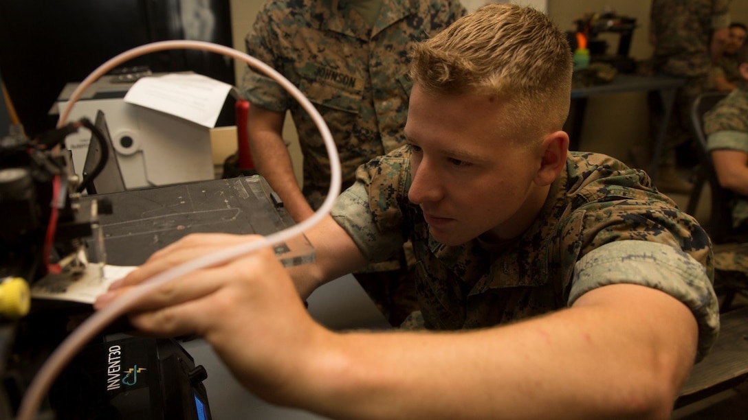 Lance Cpl. Vincent A. Smyth, Marine Air-Ground Task Force planning specialist with the Command Element, Special Purpose Marine Air-Ground Task Force - Southern Command, calibrates a three-dimensional printer during the 3-D Printing Training Course at Marine Corps Base Camp Lejeune, North Carolina, April 20, 2017. Marines from various sections of SPMAGTF-SC attended the two-day training hosted by General Support Maintenance Company, 2nd Maintenance Battalion, Combat Logistics Regiment 25, 2nd Marine Logistics Group, in order to gain hands-on experience with 3-D printers and receive instruction in computer-aided design, file creation and manufacturing.
