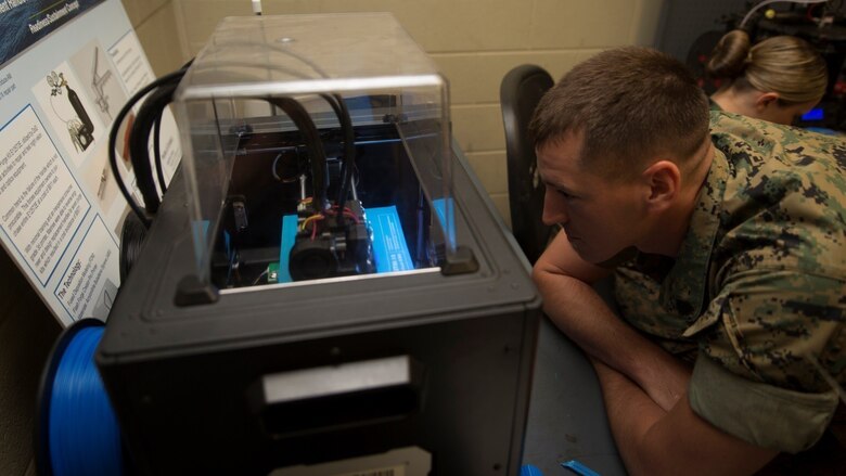 Sgt. Kenneth R. Storvick, a squad leader with the Logistics Combat Element, Special Purpose Marine Air-Ground Task Force - Southern Command, watches a three-dimensional printer create his design during the 3-D Printing Training Course at Marine Corps Base Camp Lejeune, North Carolina, April 20, 2017. Marines from various sections of SPMAGTF-SC attended the two-day training hosted by General Support Maintenance Company, 2nd Maintenance Battalion, Combat Logistics Regiment 25, 2nd Marine Logistics Group, in order to gain hands-on experience with 3-D printers and receive instruction in computer-aided design, file creation and manufacturing. 